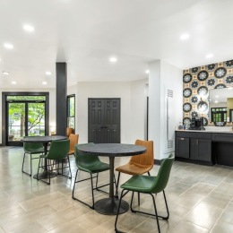 a kitchen with tables and chairs