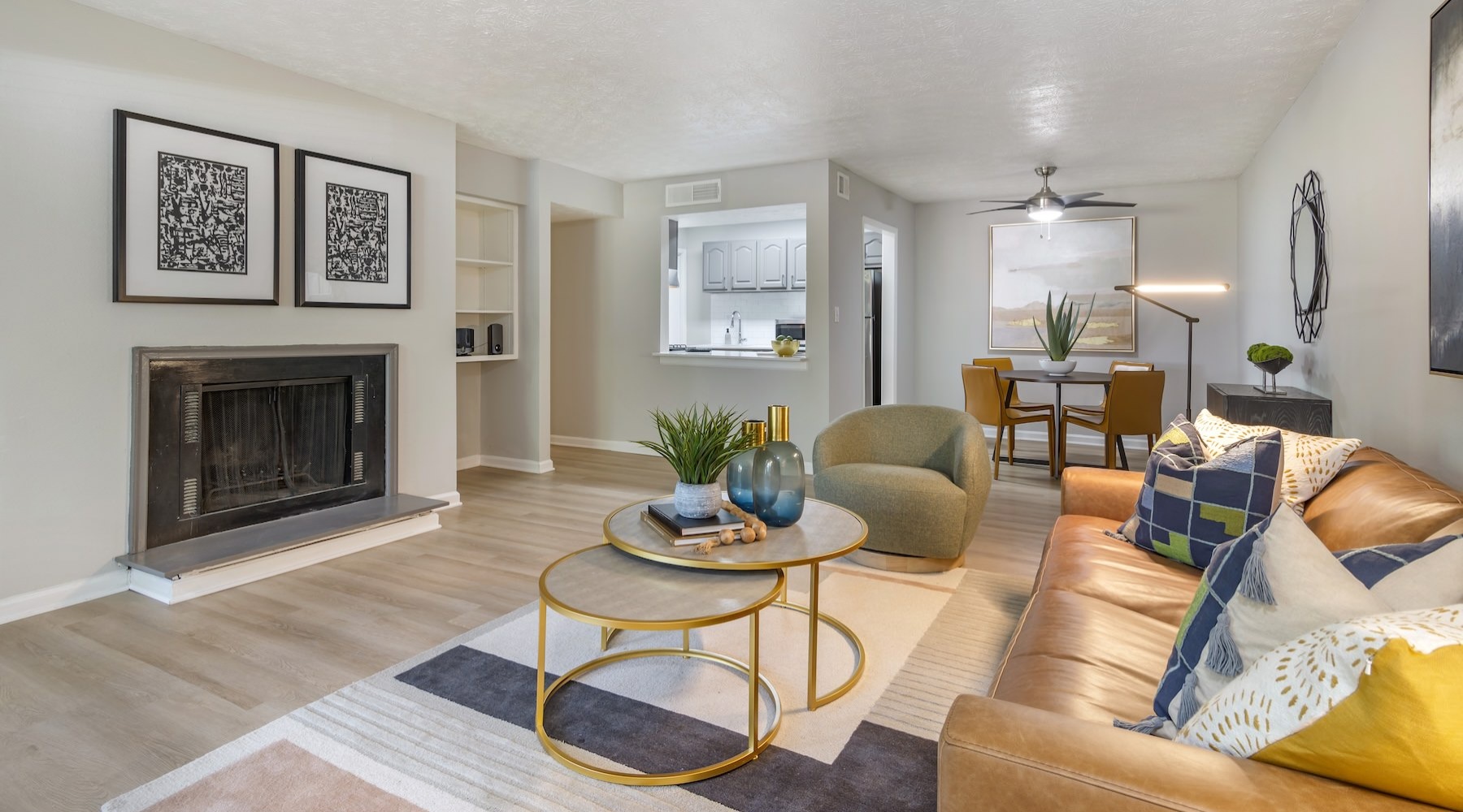 a living room with a fireplace, couch and coffee table