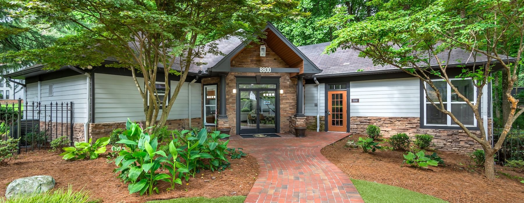 a leasing office with a brick walkway
