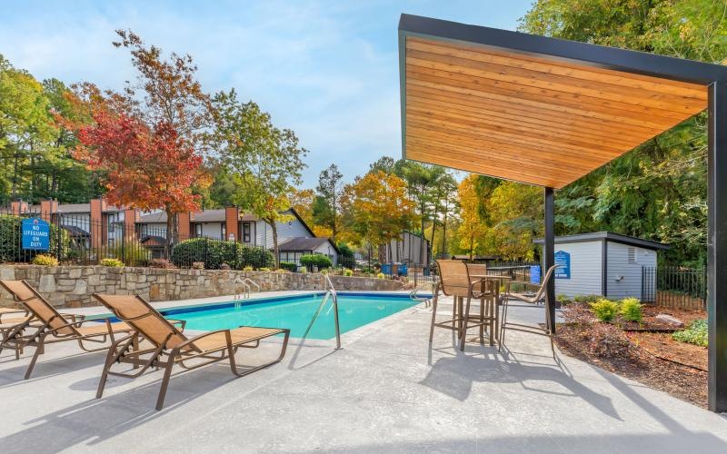 a pool and chairs outside