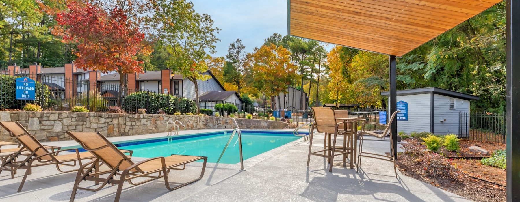 a pool and chairs outside