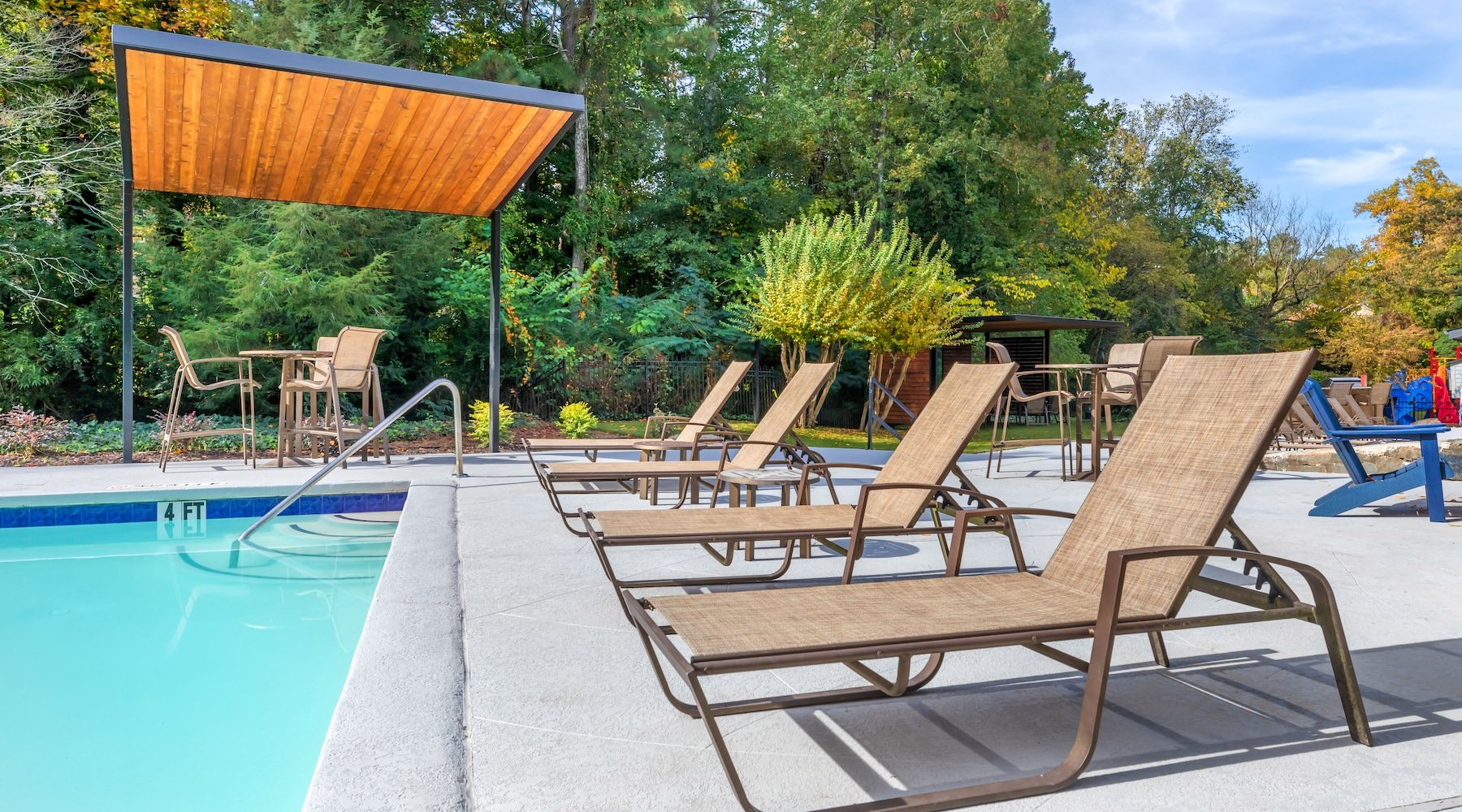 a pool with lounge chairs