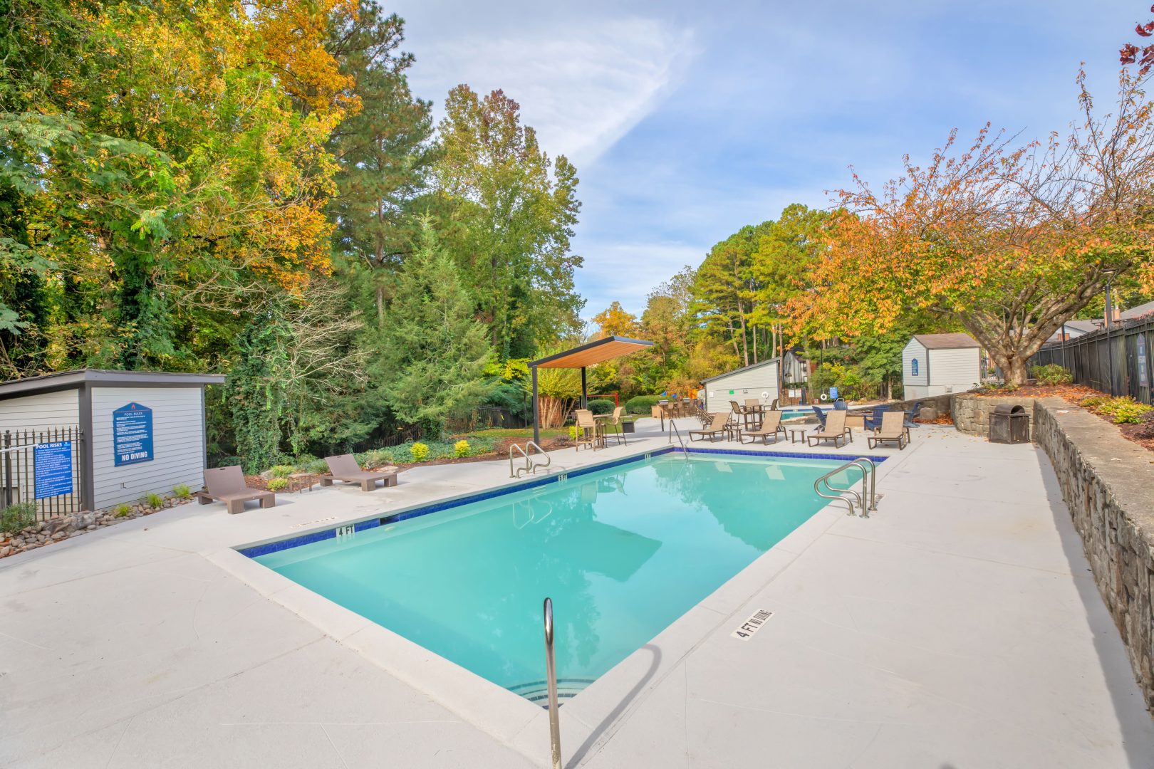 a pool in a backyard with trees and bushes at The  Bowie