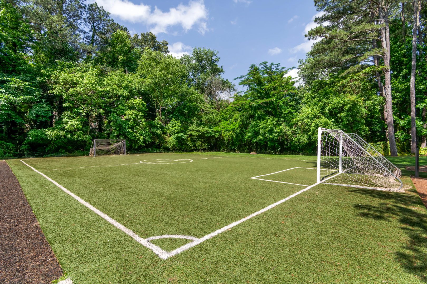 a soccer field with a goal and trees at The  Bowie